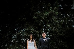 Country Club Wedding epic wide shot of bride and groom in front of trees - Photography: NST Pictures