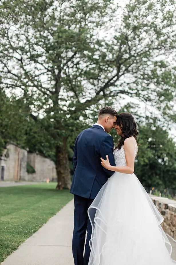 Country Club Wedding photo of bride and groom hugging outside - Bluespark Photography