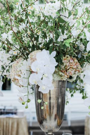 Country Club Wedding reception centerpiece with white orchids and greenery - Photography: NST Pictures