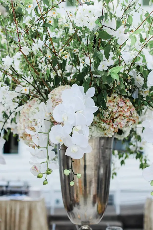 Country Club Wedding reception centerpiece with white orchids and greenery - Bluespark Photography