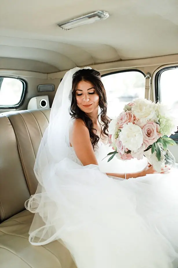 Glamorous bridal look with half up half down hair with loose curls a long veil and white and blush bride bouquet - Bluespark Photography