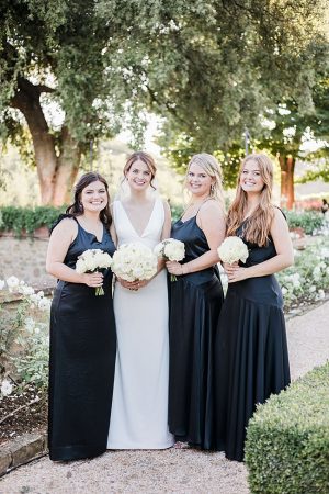 Photo of bride and bridesmaids with black bridesmaids dresses- Purewhite Photography