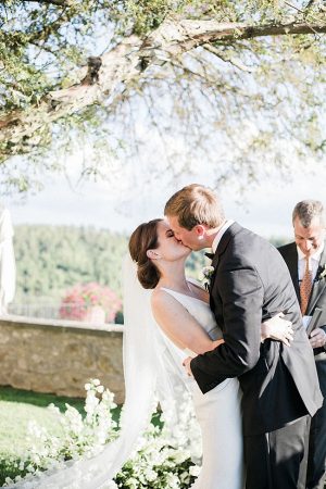 Romantic photo of bride and grooms first kiss - Purewhite Photography