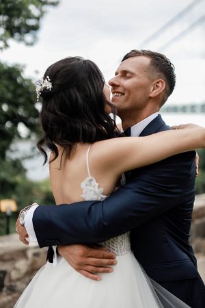 Romantic photo of groom hugging his bride - Photography: NST Pictures
