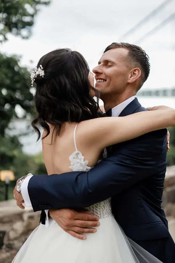 Romantic photo of groom hugging his bride - Bluespark Photography