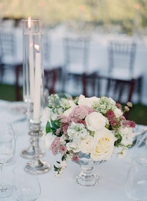 Romantic white and mauve wedding reception centerpiece with tall glass votives - Purewhite Photography