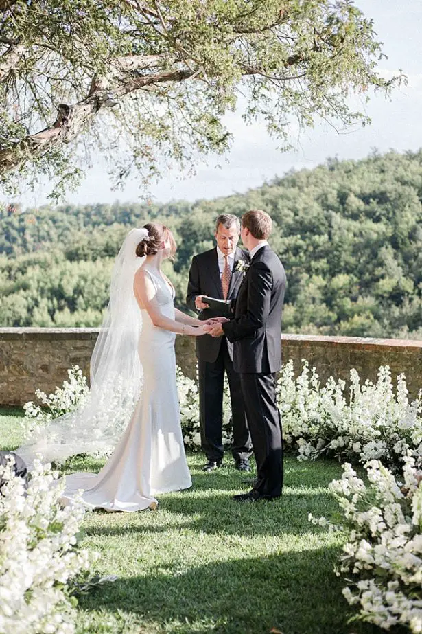 Tuscany Wedding ceremony photo of bride and groom holding hands - Purewhite Photography