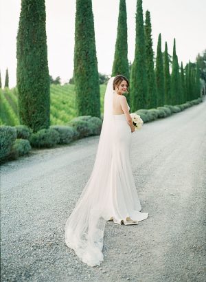 Tuscany Wedding romantic bridal portrait by cypress trees with cathedral veil- Purewhite Photography