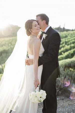 Tuscany Wedding sunset photo of bride being kissed by groom- Purewhite Photography