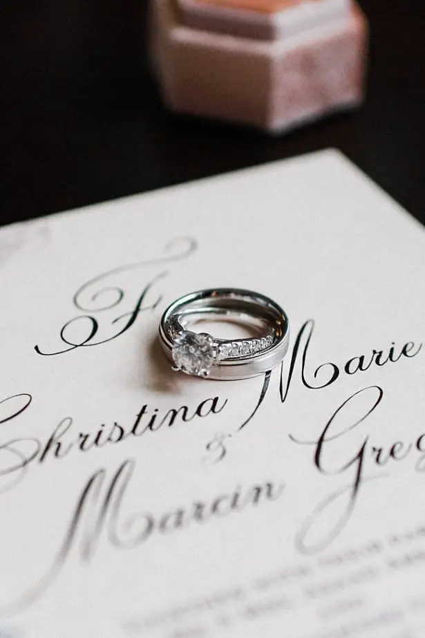 White gold wedding bands on white wedding invitations - Bluespark Photography