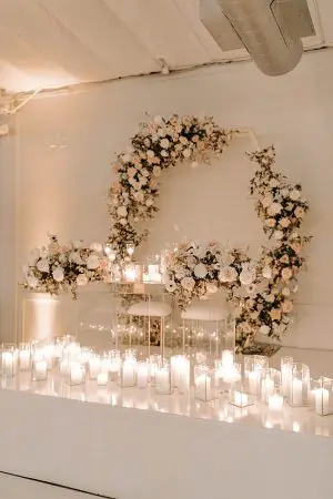 Candlelit acrylic sweetheart table with floral arch- Foolishly Rushing In Photography