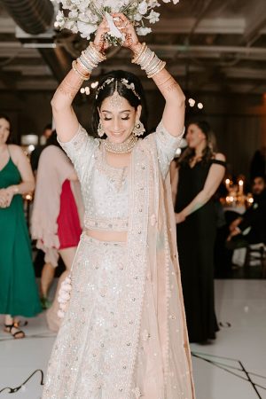 Indian bride tossing the bouquet- Foolishly Rushing In Photography