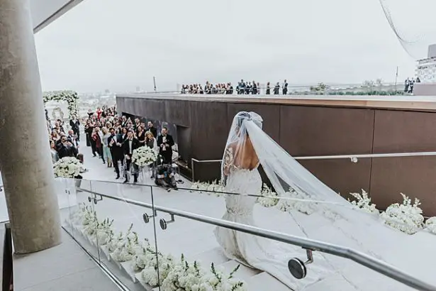 Bride walking down the aisle with backless wedding dress - Photo: Dmitry Shumanev Production