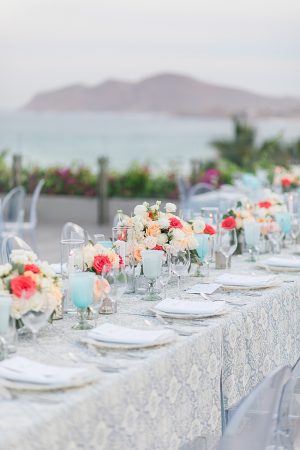 Cabo Destination Wedding overlooking the water with peach colored flower centerpieces - Photography: JBJ Pictures