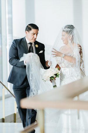Matron of honor helping bride get ready to walk down the aisle - Photo: Dmitry Shumanev Production