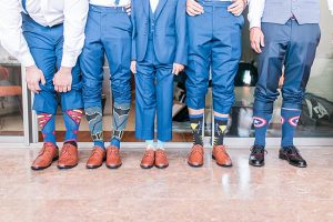 Fun photo of groom with groomsmen showing off goofy socks - Photography: JBJ Pictures