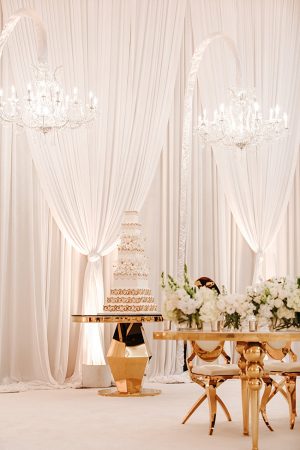 White and Gold Opulent Wedding reception with gold cake table - Photo: Dmitry Shumanev Production