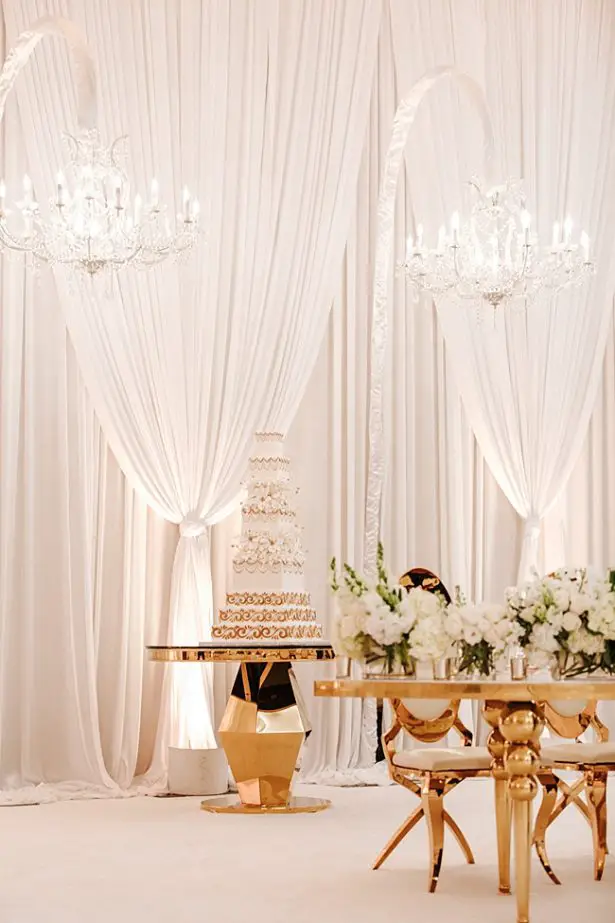 White and Gold Opulent Wedding reception with gold cake table - Photo: Dmitry Shumanev Production