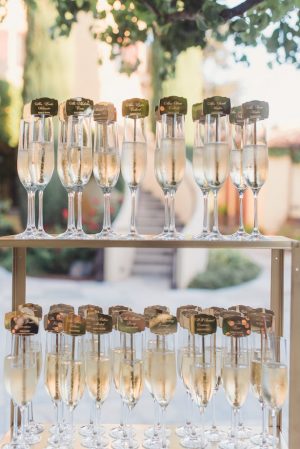 Champagne flutes and escort card display wedding details - Sun and Sparrow Photography