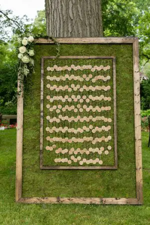 Green moss escort card display with wood frame - Photography: Emilia Jane