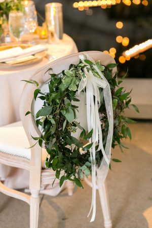 Greenery Wreath wedding chair decor - Photography: Emilia Jane