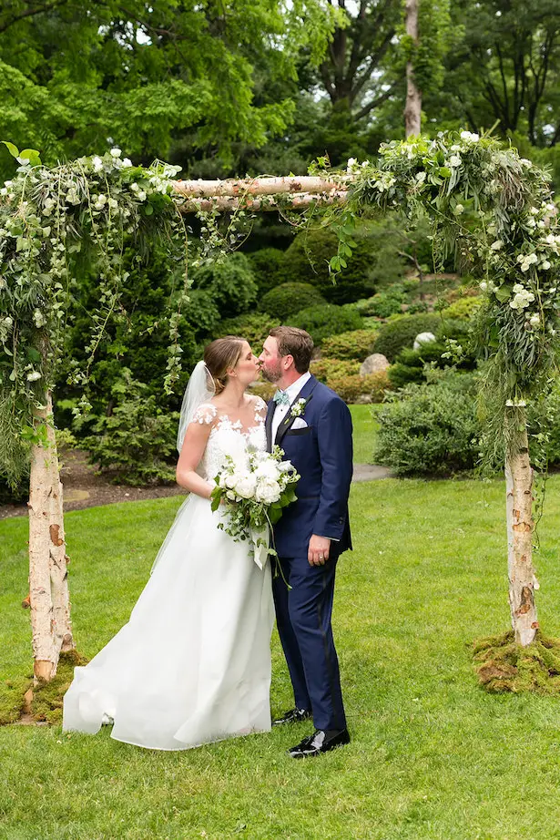 Wedding ceremony arch with sticks and greenery - Photography: Emilia Jane
