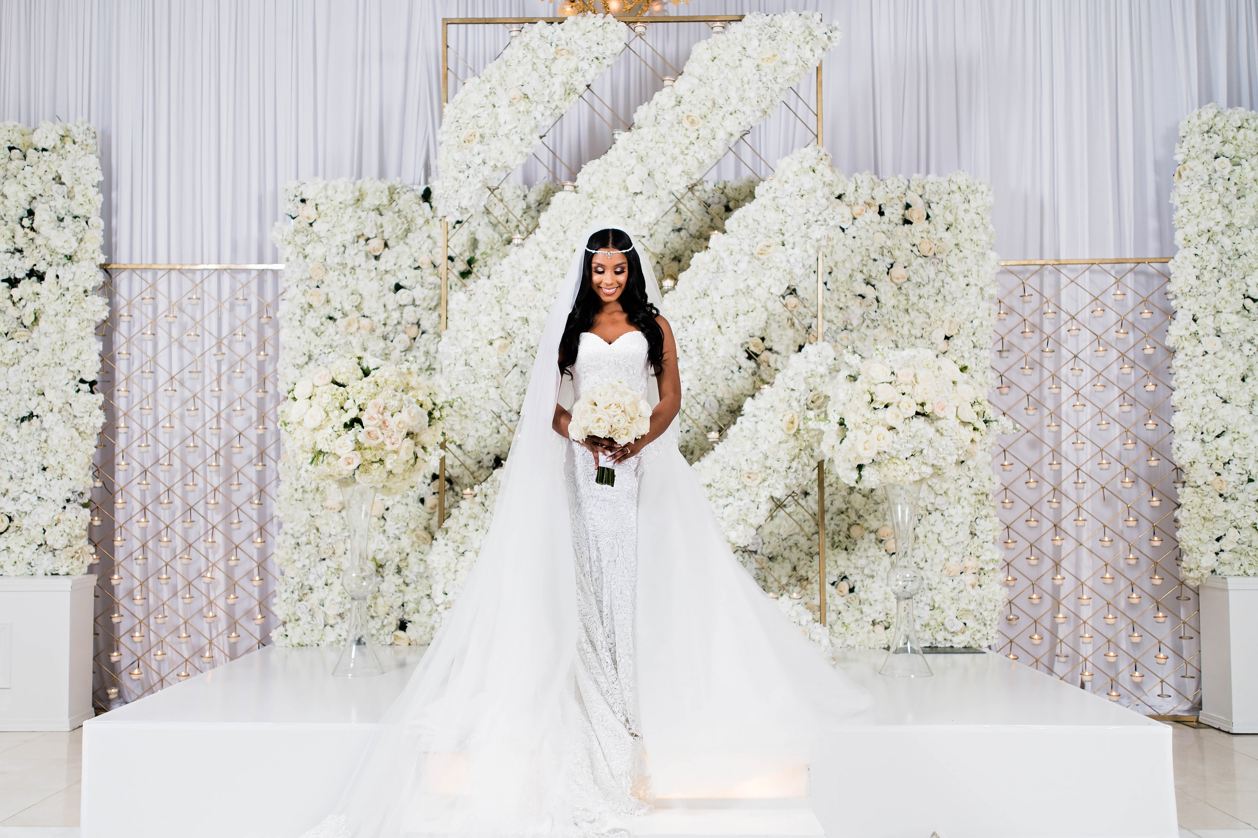 African American bride at her Luxury white floral wedding ceremony decor - Photography: Pharris Photos