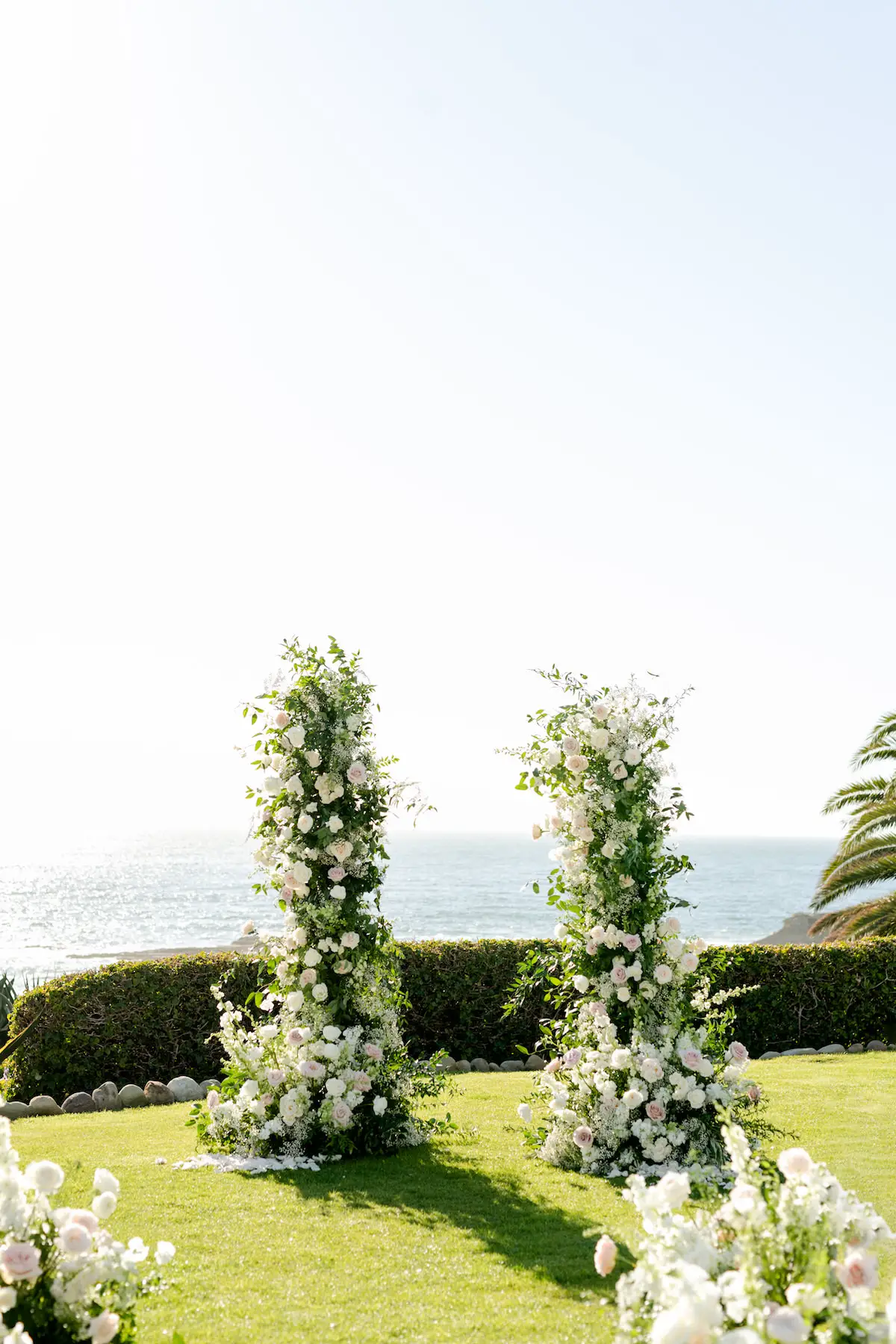 Romantic oceanside wedding ceremony decor - Holly Sigafoos Photo