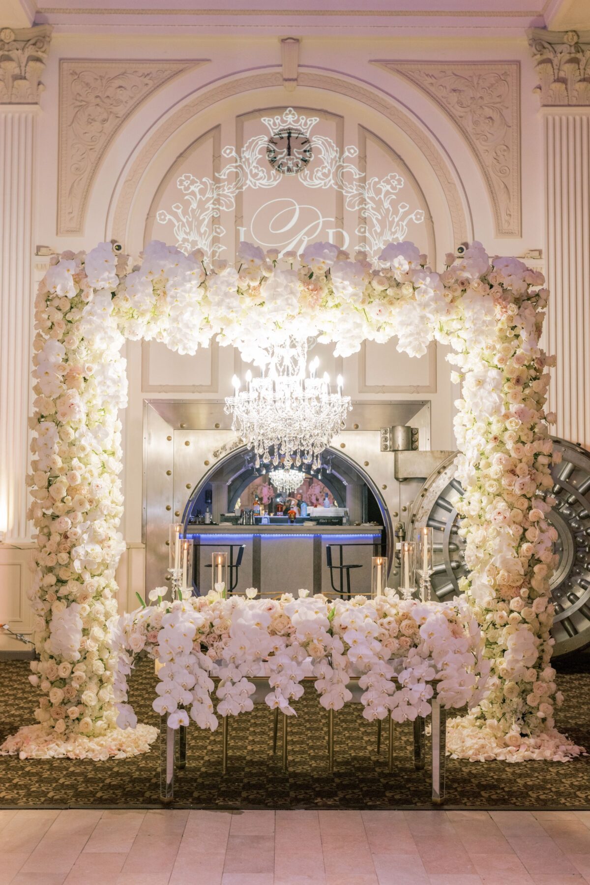 Sweetheart wedding table decor with floral archLuxury Latinx wedding - Photography: Brooke Images