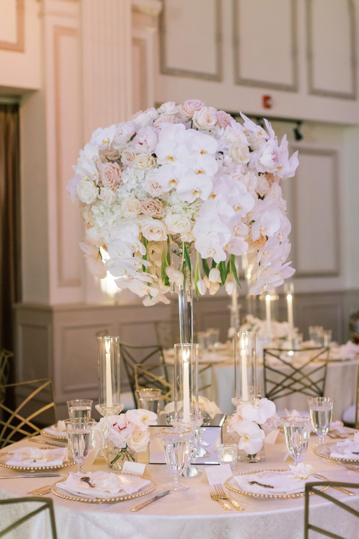 tall wedding centerpiece with orchids - Photography: Brooke Images