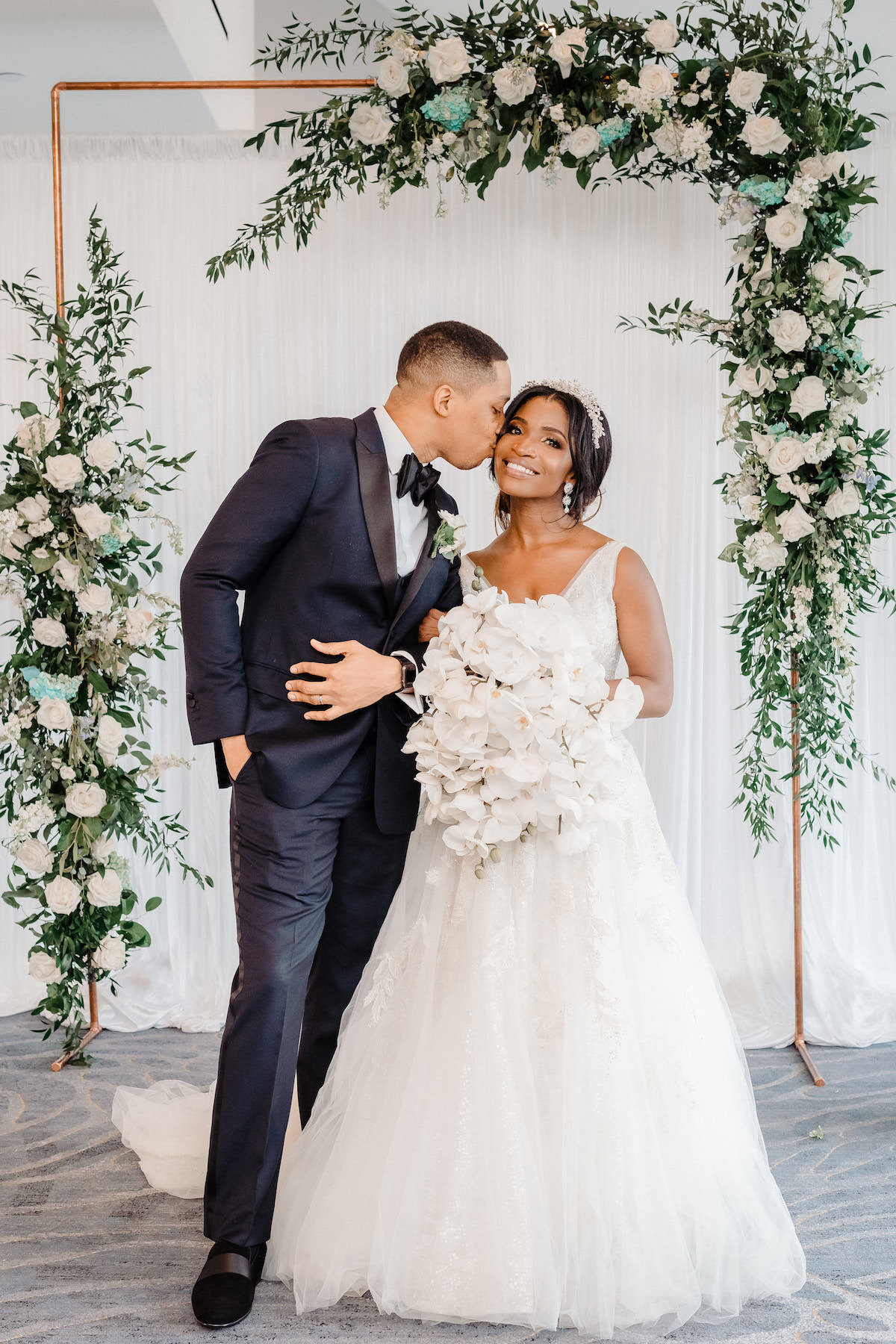 Luxury bride and groom portrait with floral arch - Tunji Studio Photography